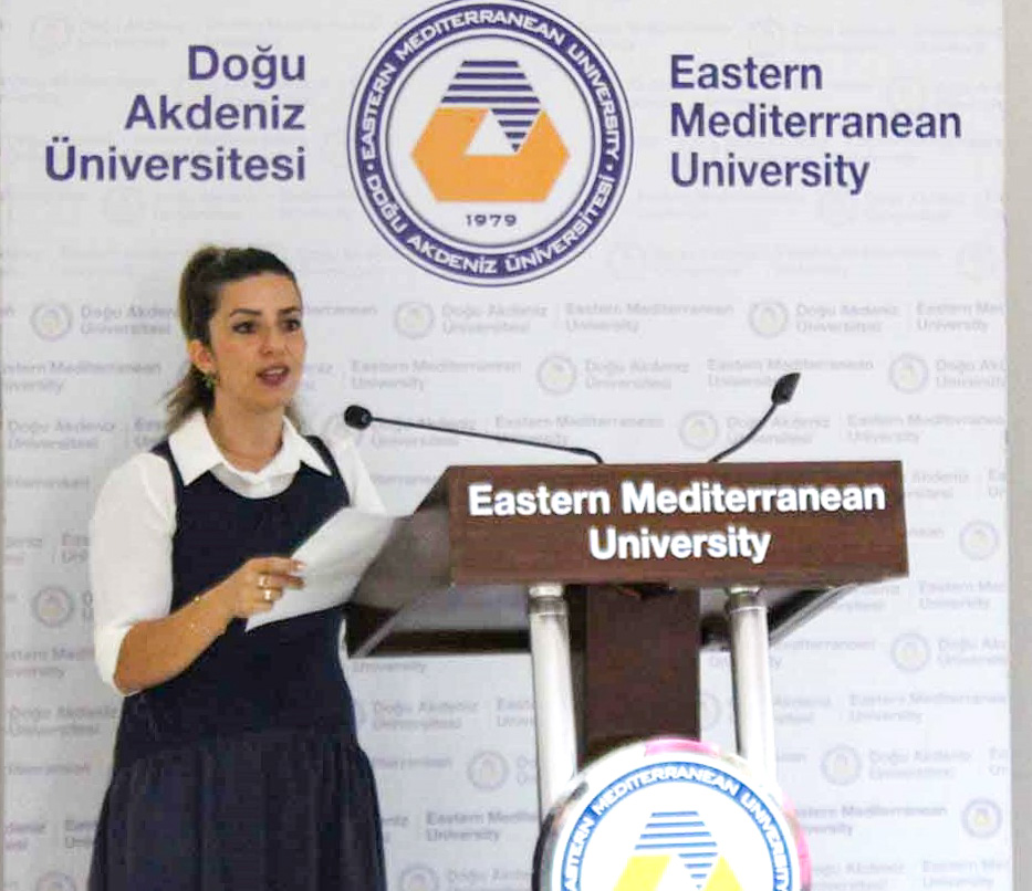 Speaker at the podium with the EMU logo